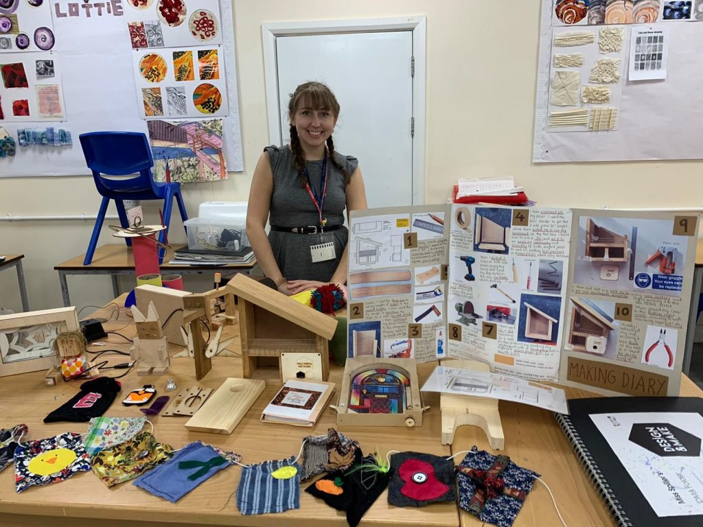 Design Technology trainee Emily showcasing some of the things she has made on the course